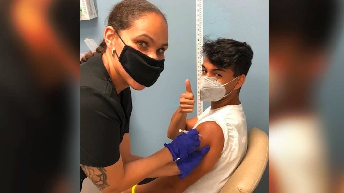 Patient giving thumbs up while getting a shot